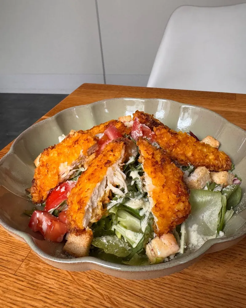 Knuspriger Hähnchen-Caesar-Salad in Keramikschale